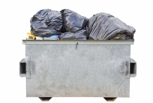 Workers safely handling builders waste