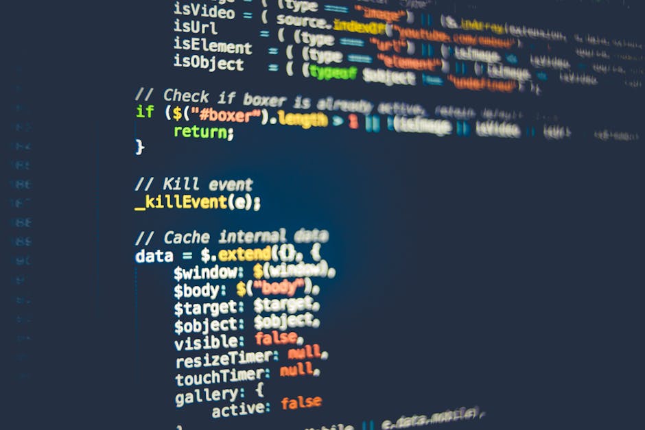 Close-up view of a computer screen displaying lines of colorful computer programming code, with an emphasis on various functions, variables, and syntax in different colors such as red, green, blue, an